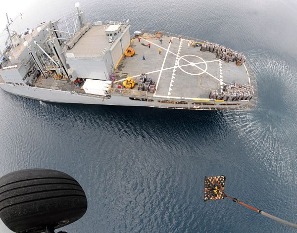A HH-60H Seahawk helicopter from Helicopter Anti-Submarine Squadron (HS) 4 lifts another pallet of bottled water from the deck of Military Sealift Command combat stores ship USNS Niagara Falls (T-AFS 3) for delivery to Kalibo, Republic of the Philippines. Kalibo is on the northern tip of Panay Island and was hit hard by the typhoon.