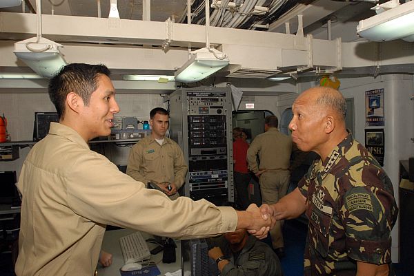Armed Forces of the Philippines, Chief of Staff, Gen. Alexander B. Yano shares a handshake with Lt.j.g. Eduardo Vargas