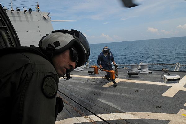 Aviation Warfare Systems Operator 2nd Class Anthony Chavez, of San Bernardino, Calif., looks out from an SH-60F Seahawk assigned to the 
