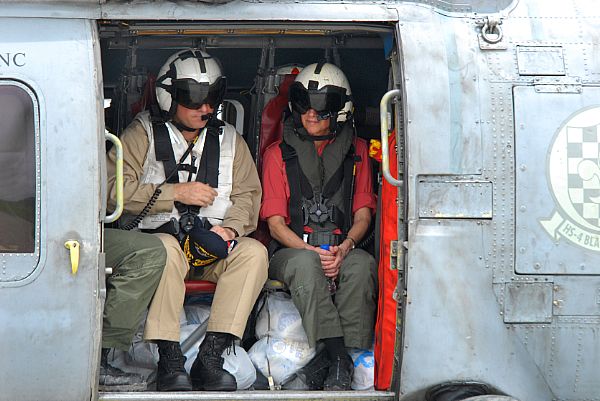 Commander Carrier Strike Group Seven, Rear Adm. James P. Wisecup and U.S. Ambassador to the Philippines, Kristie A. Kenney, prepare to take a helicopter ride in an HH-60H Seahawk assigned to the 