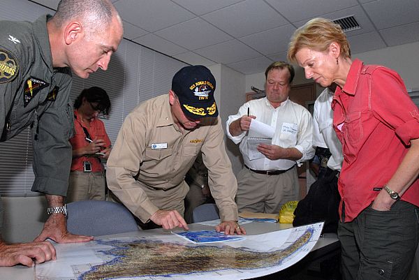 Commander Carrier Strike Group Seven, Rear Adm. James P. Wisecup, center shows U.S. Ambassador to the Philippines, Kristie A. Kenney, the areas in the Philippines where USS Ronald Reagan (CVN 76) has delivered supplies during their relief efforts in support of the Philippine government. American and Philippine military and government leaders met at Iloilo Airport to share their goals and show their support for the Typhoon Fengshen relief effort.