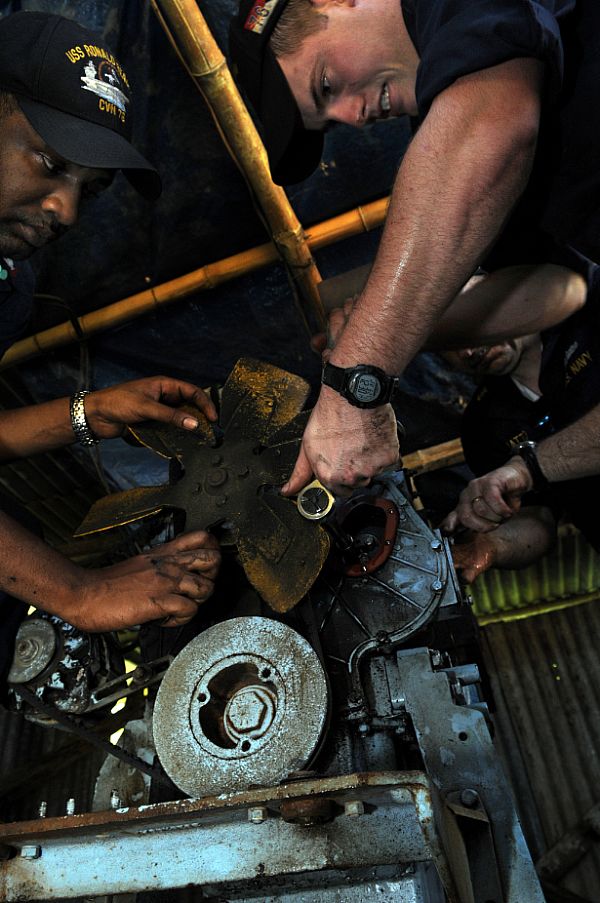 Engineman 2nd Class Shane Whittington, of Quitman, Texas, right, and Electrician's Mate 2nd Class Dante Pine, of Compton, Calif., remove a fuel pump on a generator at Barotac Viejo Regional Hospital in Iloilo. The Sailors, assigned to Engineering Department aboard the Nimitz-class aircraft carrier USS Ronald Reagan (CVN 76), have been inspecting, troubleshooting and repairing generators at hospitals in need of clean water and electricity after Typhoon Fengshen. 