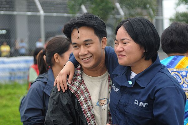 Storekeeper Seaman Grace Geroche, a native of Iloilo and Sailor assigned to the Nimitz-class aircraft carrier USS Ronald Reagan (CVN 76), embraces her brother upon arriving as part of U.S. Navy relief operations. Her family nearly lost their lives in flooding caused by Typhoon Fengshen.