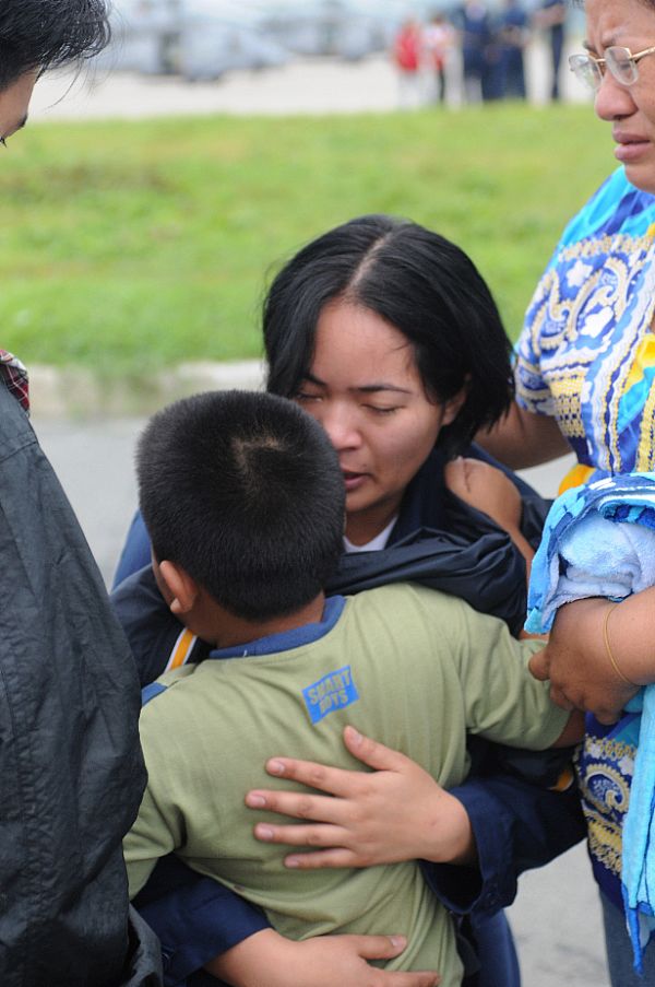 Storekeeper Seaman Grace Geroche, a native of Iloilo and Sailor assigned to the Nimitz-class aircraft carrier USS Ronald Reagan (CVN 76), embraces her younger brother upon arriving as part of U.S. Navy relief operations. Her family nearly lost their lives in flooding caused by Typhoon Fengshen. 