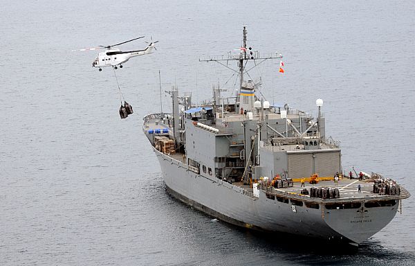 Super PUMA helicopters fly much needed bottled water to Kalibo, Republic of the Philippines from the deck of the Military Sealift Command combat stores ship USNS Niagara Falls (T-AFS 3) in the wake of Typhoon Fengshen