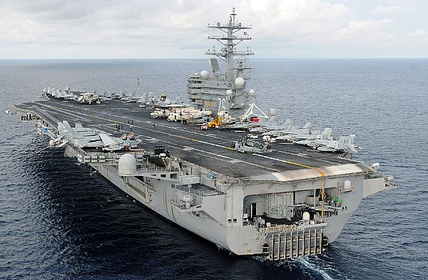 The aircraft carrier USS Ronald Reagan (CVN 76) steams off the coast of the Philippine Island of Panay preparing to launch helicopters assigned to the 