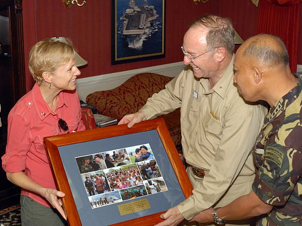 U.S. Ambassador to the Philippines, Kristie A. Kenney is presented with a collection of photos depicting relief efforts by USS Ronald Reagan (CVN 76), and other ships in her group