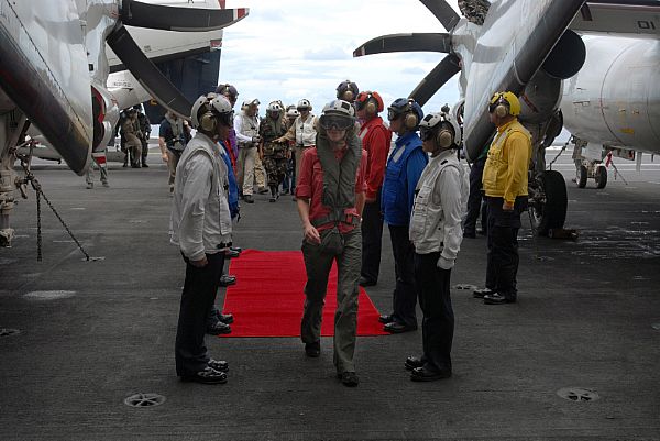 U.S. Ambassador to the Republic of the Philippines, Kristie Kenney is welcomed by rainbow sideboys, following her first arrested landing aboard USS Ronald Reagan (CVN 76). Ambassador Kenney flew aboard along with Armed Forces of the Philippines Chief of Staff, General Alexander B. Yano and Republic of the Philippines Senator Dick Gordon to discuss relief efforts.